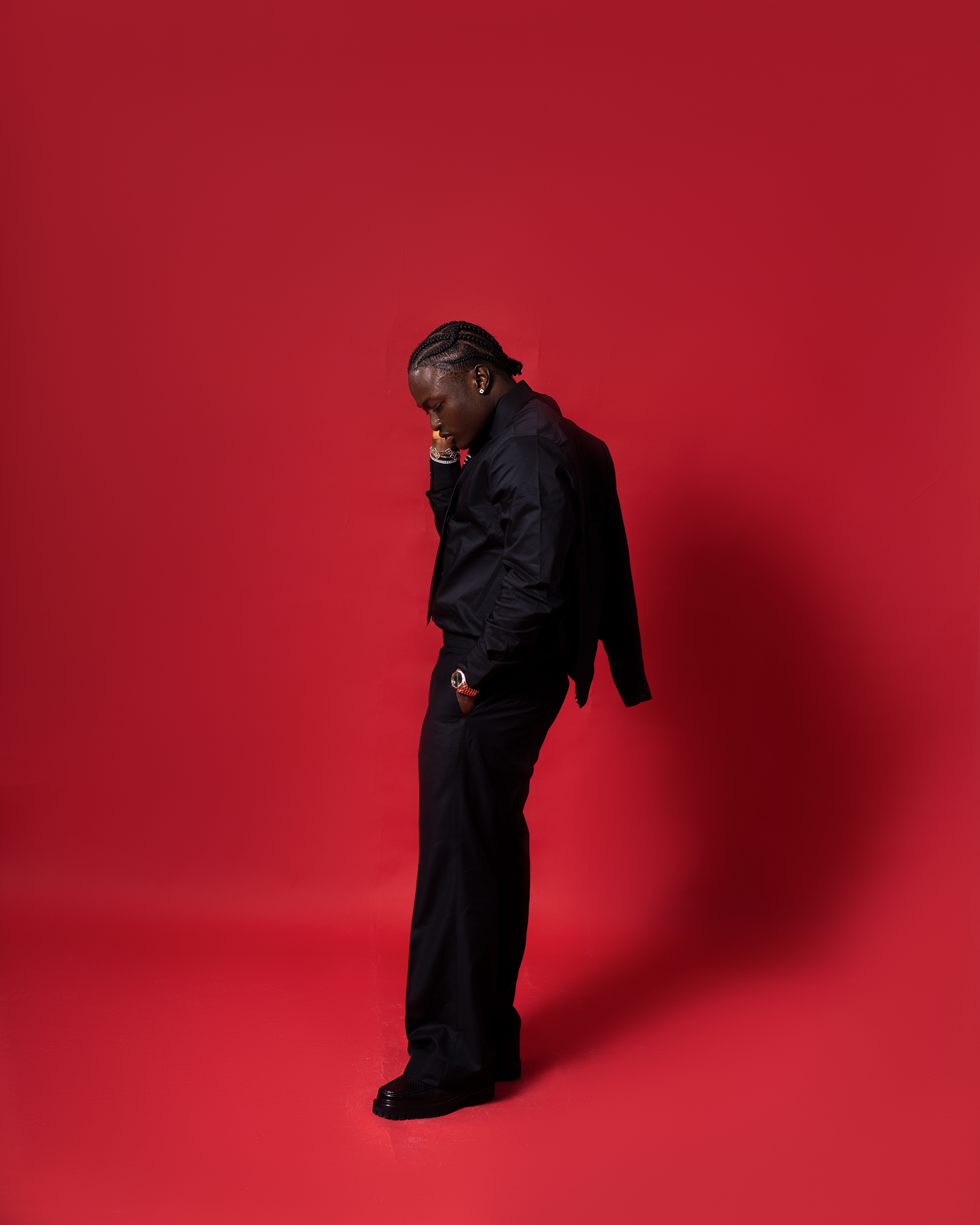 Crimson profile — all-black outfit against red background