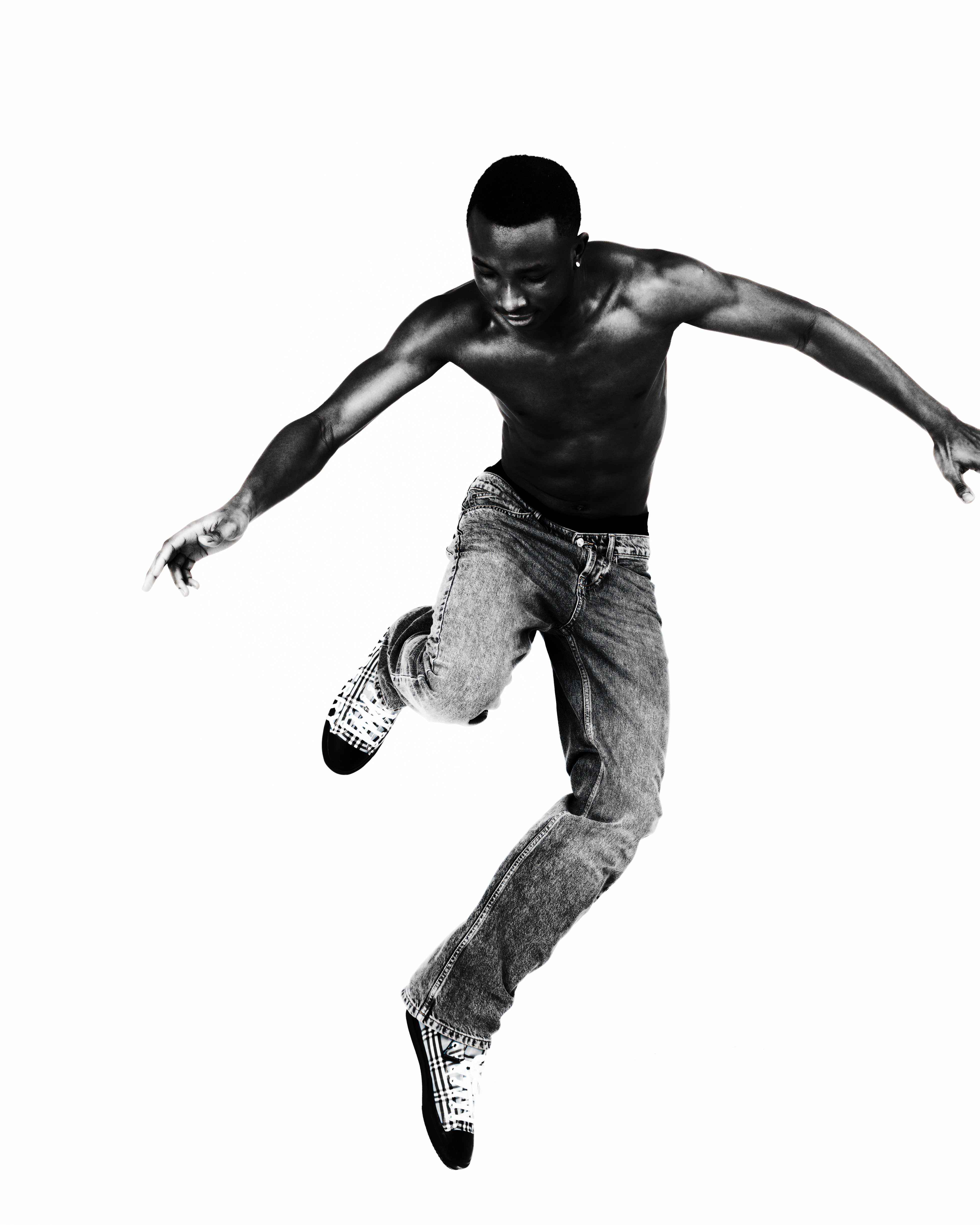 Black and white portrait — man jumping mid-air